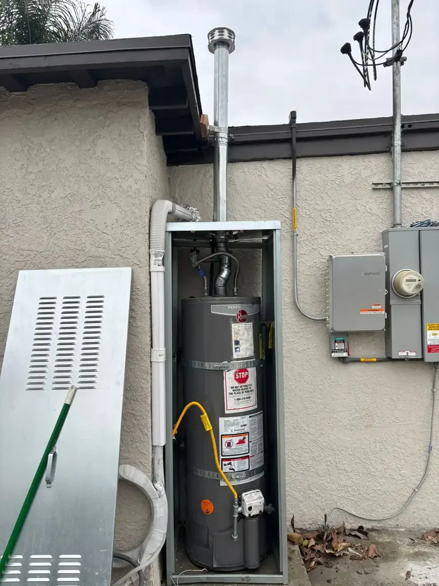 Gas tank water heater installed in an outdoor enclosure